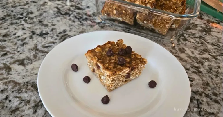 Single banana chocolate oat breakfast bar on a plate with chocolate chips