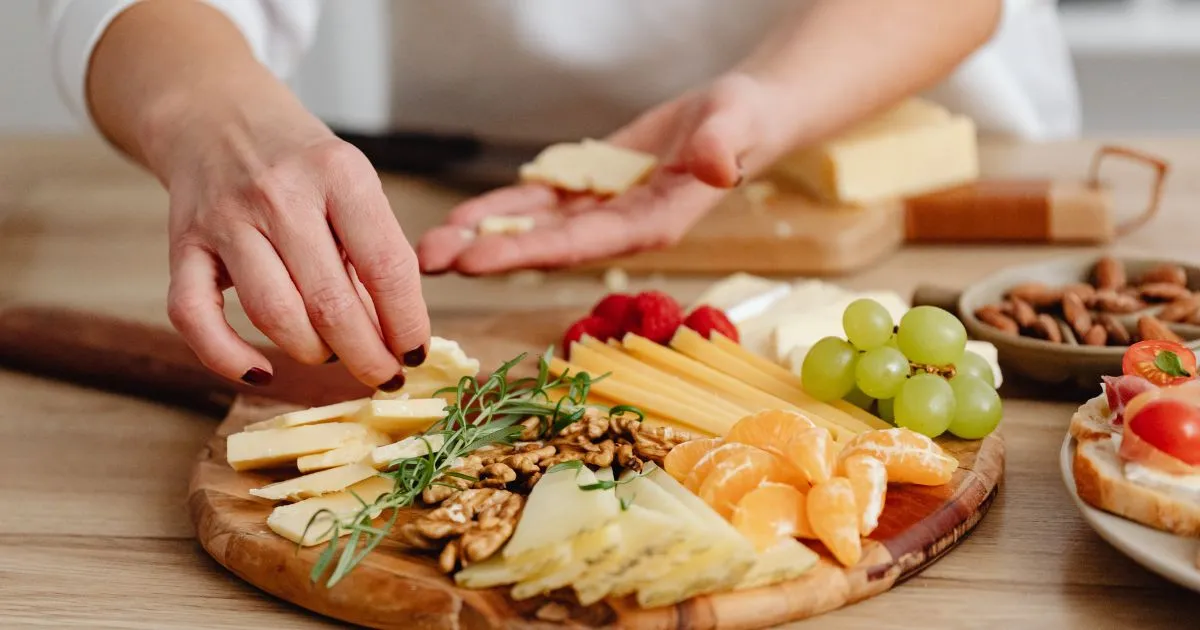 Delicious holiday party snacks with assorted cheese, meats, grapes, and crackers, perfect for family or social gatherings.